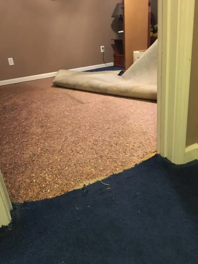 Carpet pad removal revealing water damage during Drying & Dehumidification in Okmulgee